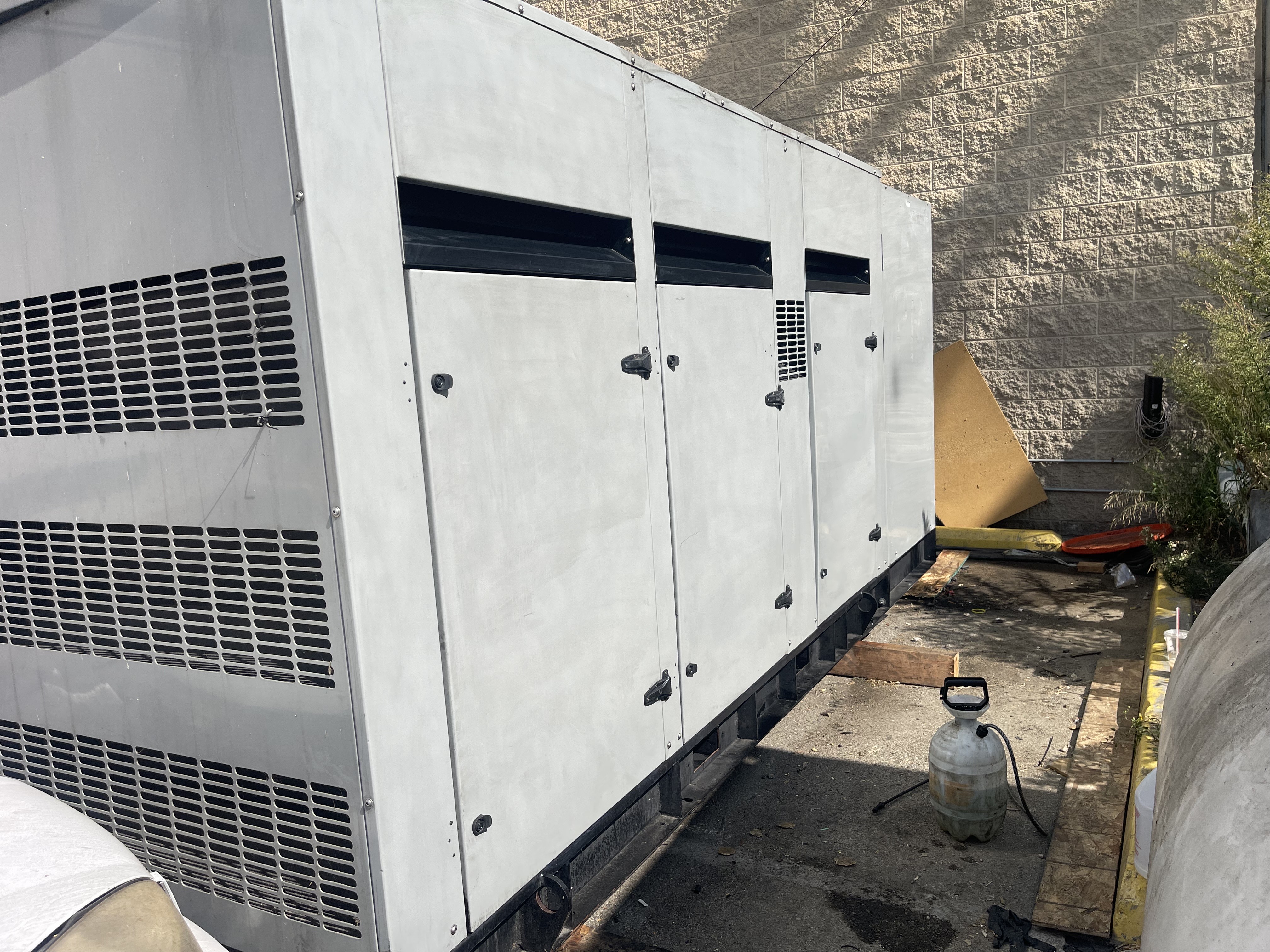 A large air conditioner sitting on top of a parking lot