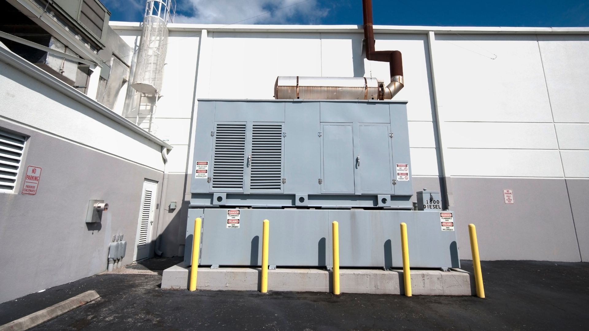 A large gray machine sitting in front of a building